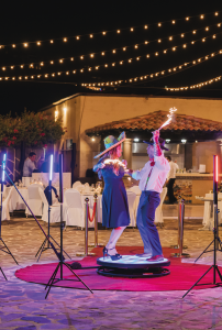 Colorful wedding dance at EMweddings outdoor celebration under string lights.