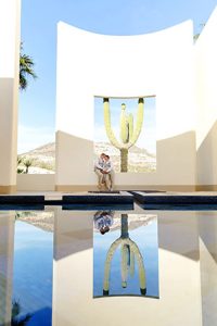Vibrant outdoor wedding ceremony with iconic cactus backdrop at EMweddings.